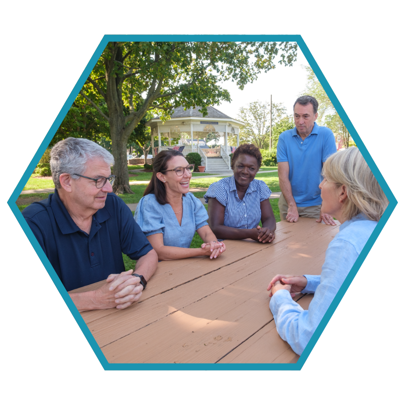 Jennifer Leeper at a community roundtable discussion around an outdoor picnic table